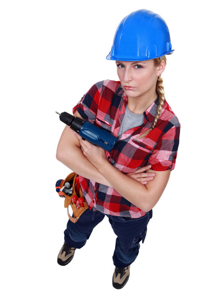 Aggressive female builder holding drill - Фото, зображення