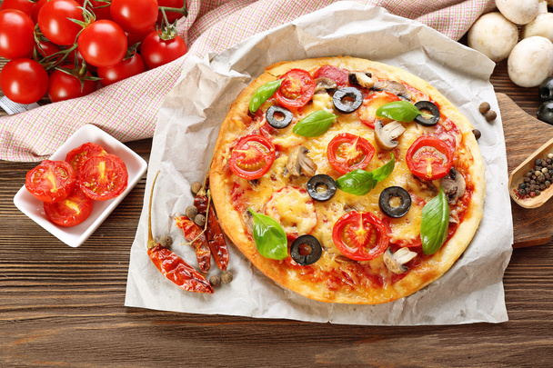 Tasty pizza with vegetables and basil on table close up - Foto, Imagen