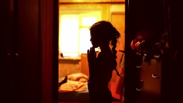 teen girl praying silhouette in corridor brown evening religion - Footage, Video