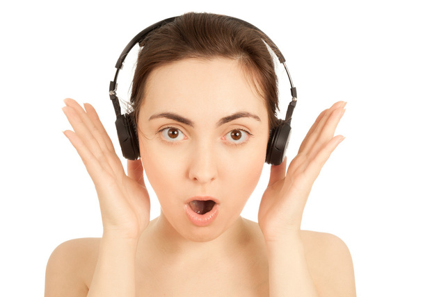 Surprised woman in headphones isolated on white - Foto, Bild