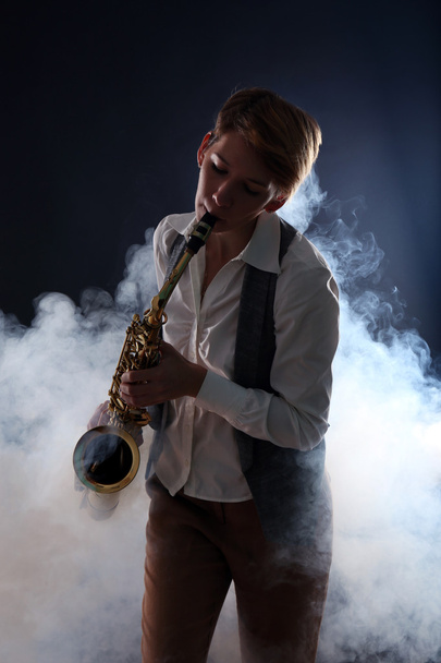 Attractive woman plays saxophone - Photo, Image