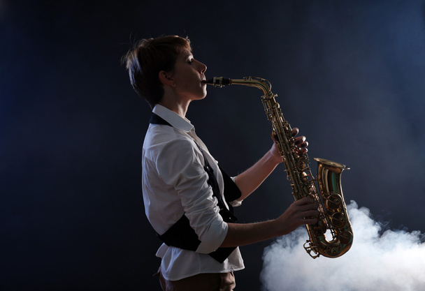 Attractive woman plays saxophone - Φωτογραφία, εικόνα