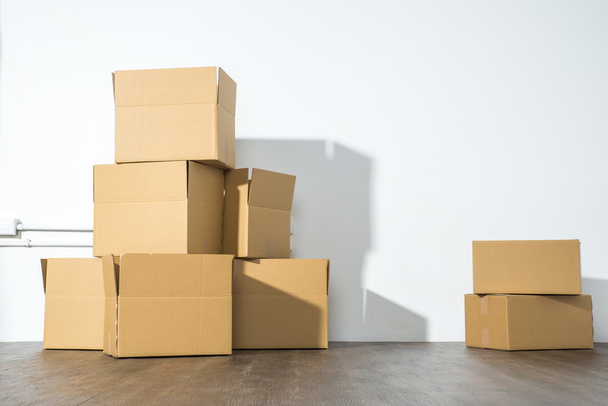 Pile of cardboard boxes on white background with box shadow - Foto, imagen