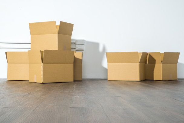 Pile of cardboard boxes on white background with box shadow - Fotó, kép