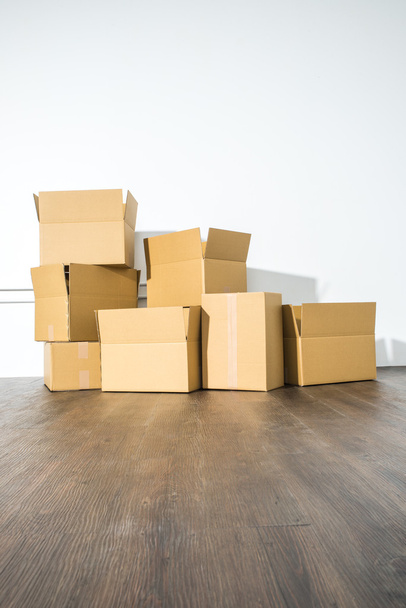 Pile of cardboard boxes on white background with box shadow - Foto, Imagen