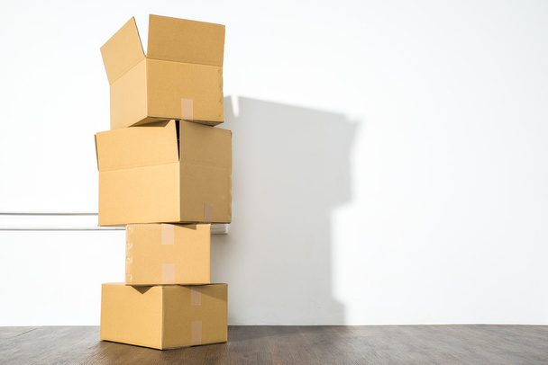 Pile of cardboard boxes on white background with box shadow - Fotoğraf, Görsel