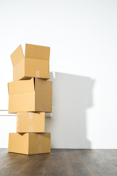Pile of cardboard boxes on white background with box shadow - Fotoğraf, Görsel