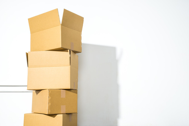 Pile of cardboard boxes on white background with box shadow - Fotografie, Obrázek