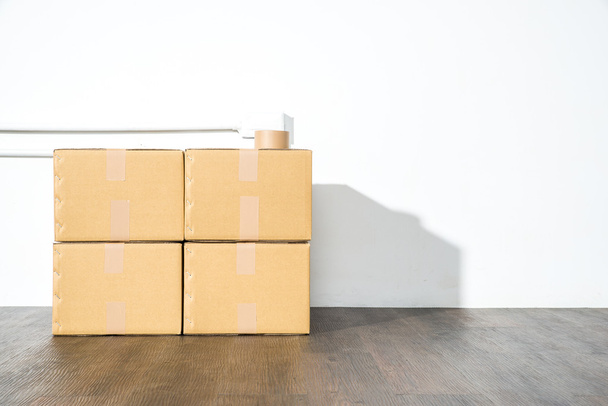 Pile of cardboard boxes on white background with box shadow - 写真・画像