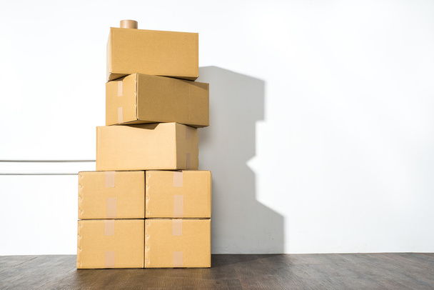 Pile of cardboard boxes on white background with box shadow - Photo, image