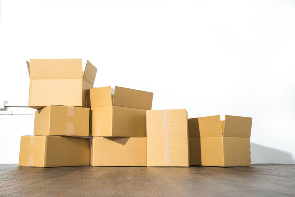 Pile of cardboard boxes on white background with box shadow - Foto, Bild