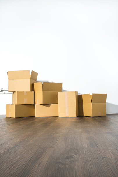 Pile of cardboard boxes on white background with box shadow - Foto, afbeelding
