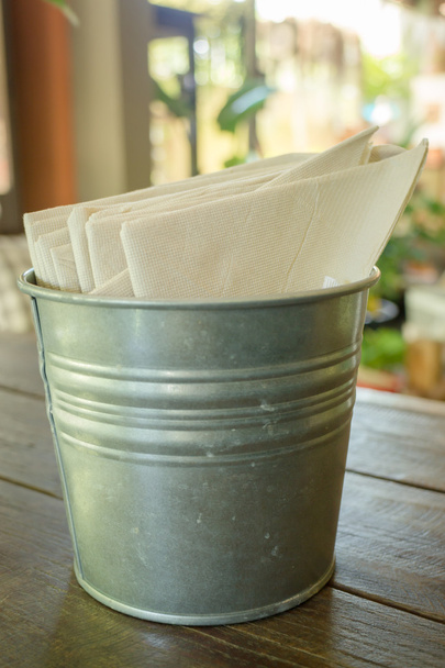 Tissue paper in bucket on wooden table - Photo, Image