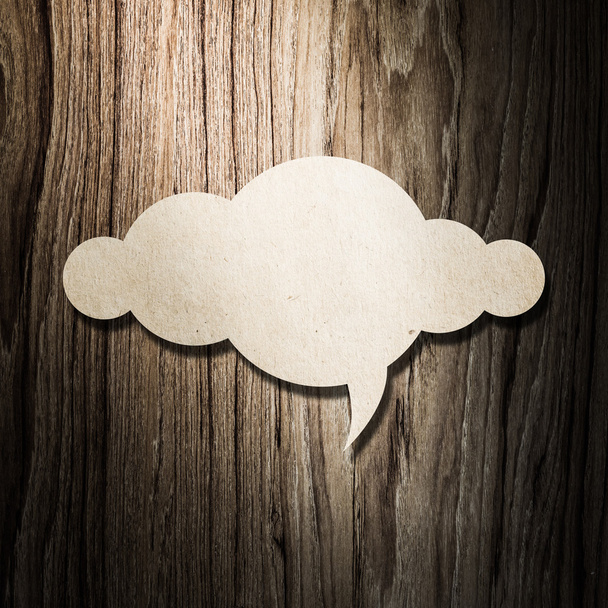 Cloud paper on wooden background - Foto, afbeelding