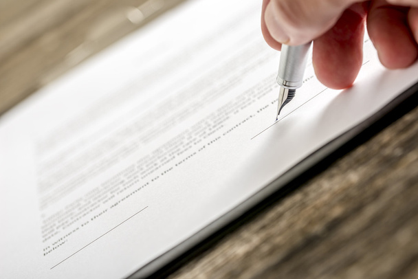 Man signing business document, subscription form or insurance pa - Fotó, kép