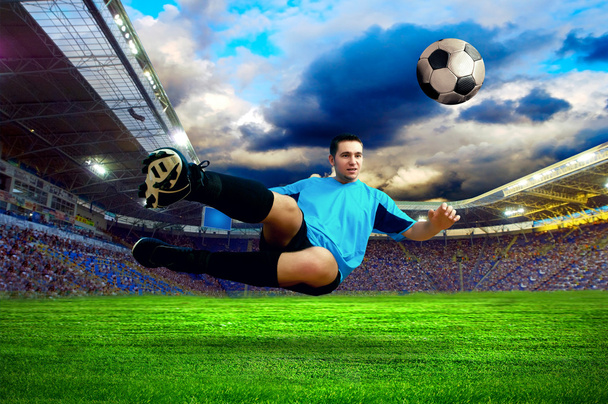 Football player on field of stadium - Фото, изображение