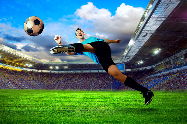 Football player on field of stadium - 写真・画像