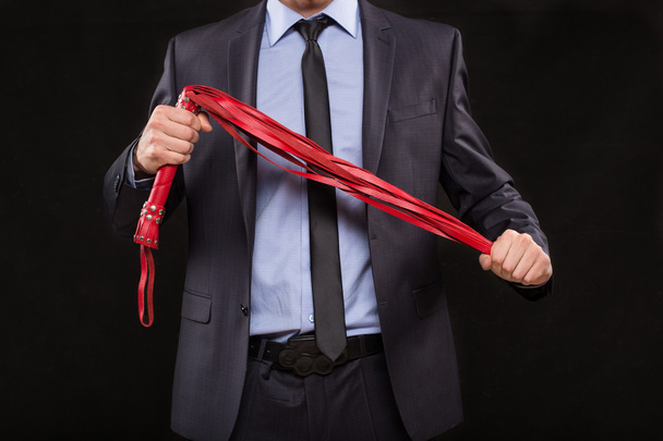 man in business suit with chained hands. handcuffs for sex games - 写真・画像