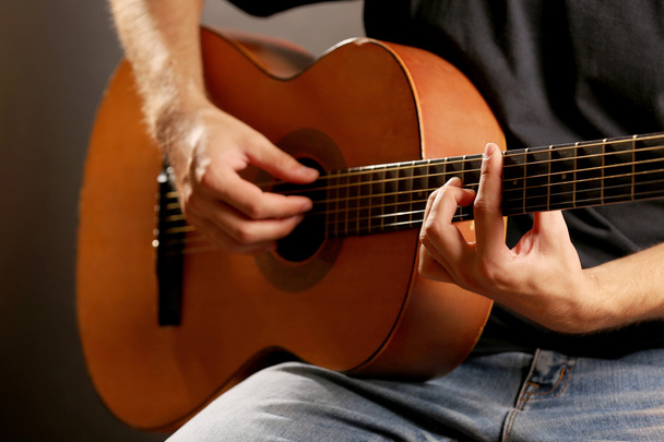 Young musician playing acoustic guitar - Foto, Bild