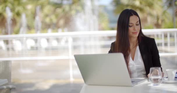 Attractive woman working from an open-air patio - Footage, Video