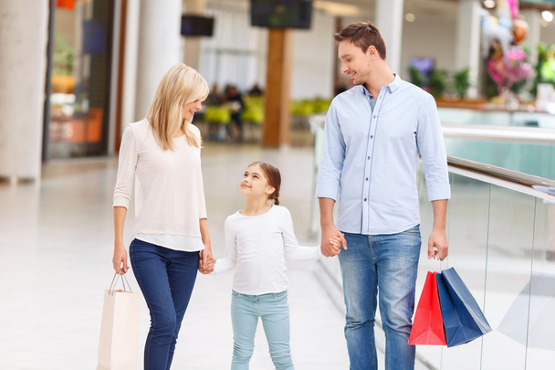 Friendly family walking around shopping mall - Фото, зображення