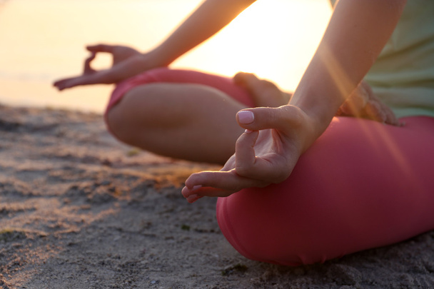 woman meditating yoga on the beach - Photo, Image
