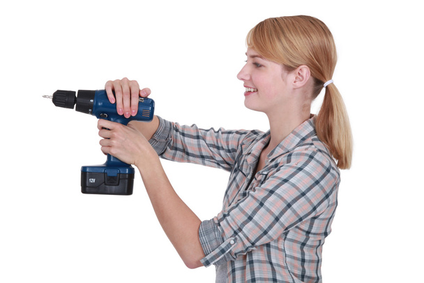 Woman using drill - Фото, зображення
