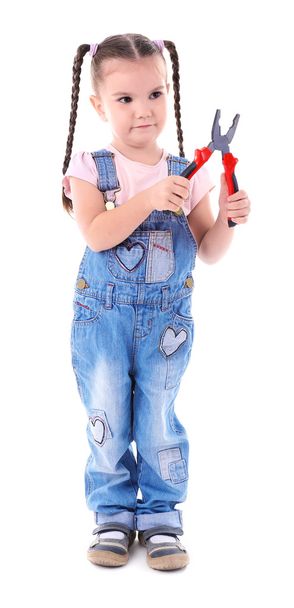 Cute little girl in overall with pliers - Fotografie, Obrázek