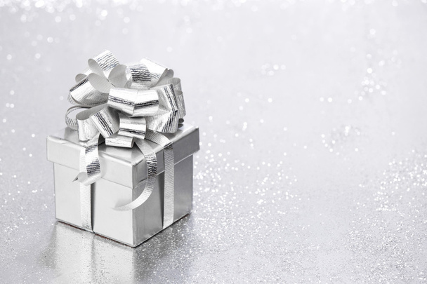 Hermosa caja de regalo de vacaciones decorada con arco de plata
 - Foto, imagen