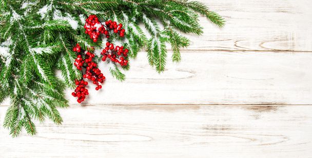 Christmas decoration border. Fir tree branch with red berries - 写真・画像