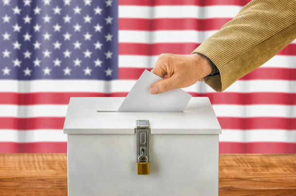 Man putting a ballot into a voting box - USA - Zdjęcie, obraz