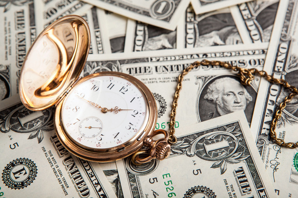 золотий годинник і доларові купюри
 - Фото, зображення