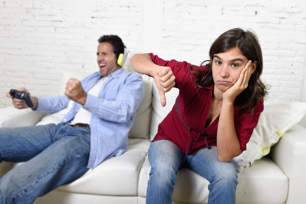 woman  angry and upset while husband or boyfriend plays videogames ignoring her - Photo, Image