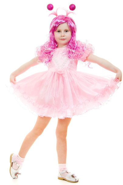 A girl with pink hair in a pink dress dancing on a white background. - Photo, Image