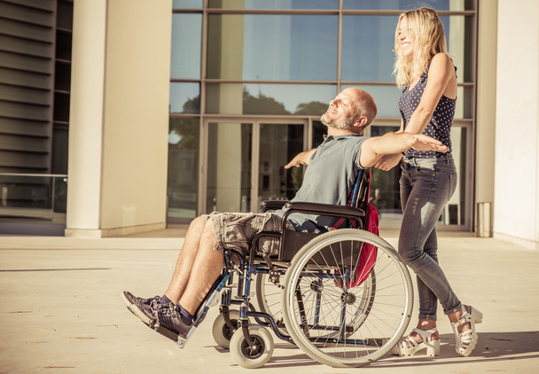 Woman and her boyfriend on the wheelchair - Fotoğraf, Görsel