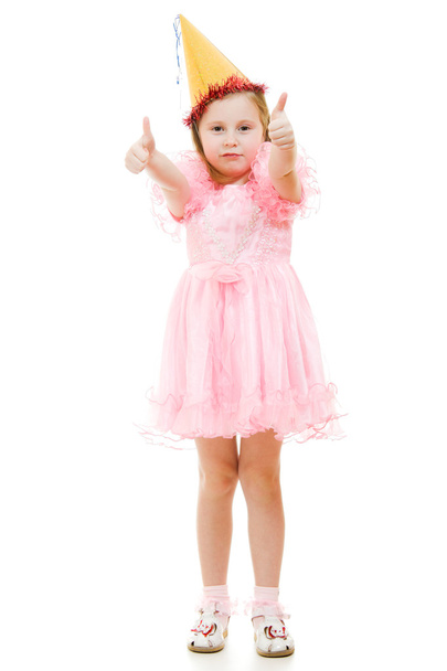 A girl in a pink dress and hat with a gesture shows okay on a white backgro - Фото, зображення