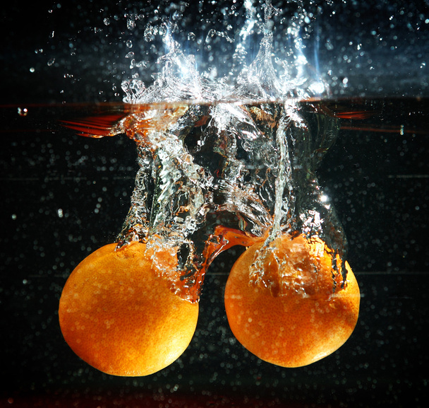 orange splash  in water - Fotoğraf, Görsel