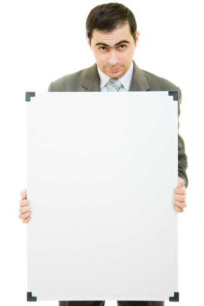 A businessman with a white board on a white background. - Photo, Image