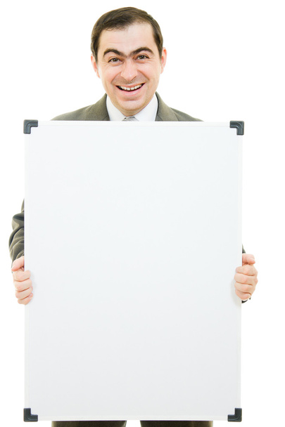 A businessman with a white board on a white background. - Zdjęcie, obraz