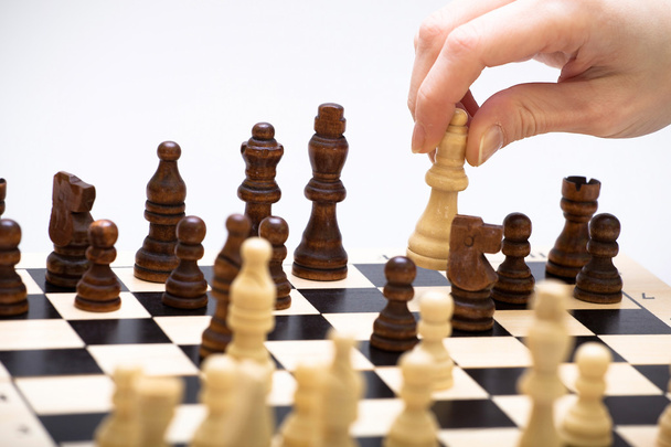 the chess game and a hand - Zdjęcie, obraz