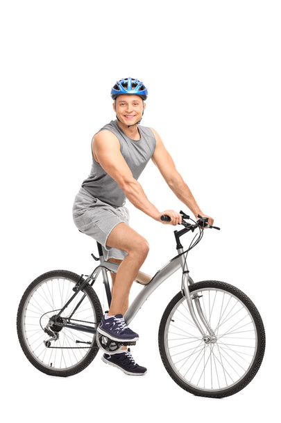 Man with a blue helmet sitting on bike - Фото, изображение