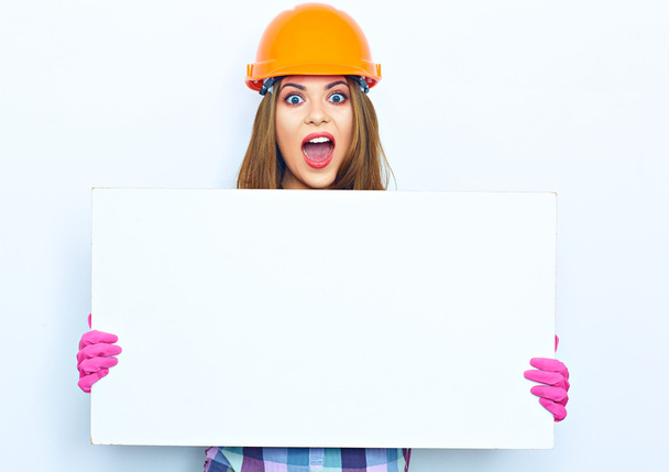 female builder holding big board - Фото, зображення