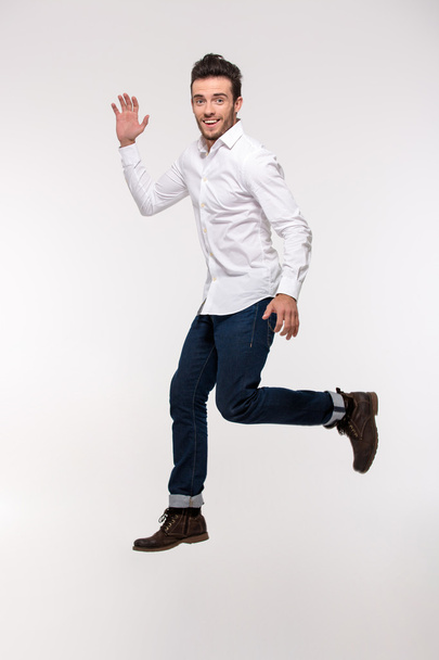 Portrait of a funny man jumping - Foto, afbeelding