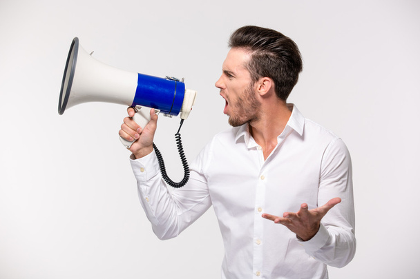 Portrait of a man yelling in megaphone - Photo, Image