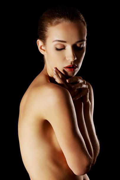 Sensual portrait of nude woman on dark background - Фото, зображення
