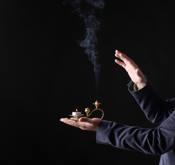 candle smoke in hands - Foto, afbeelding