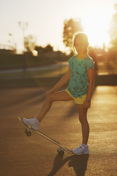 cute little girl with skateboard outdoors - Foto, Imagen
