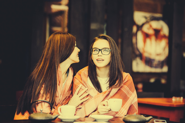 Two young and beautiful girls gossiping - Photo, Image