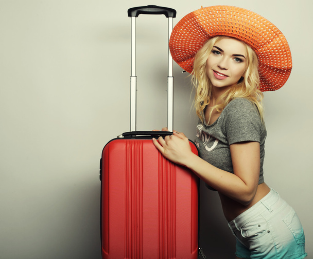 young woman  with orange travel bag - Фото, изображение