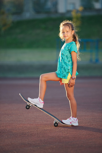 cute little girl with skateboard outdoors - Foto, Imagem